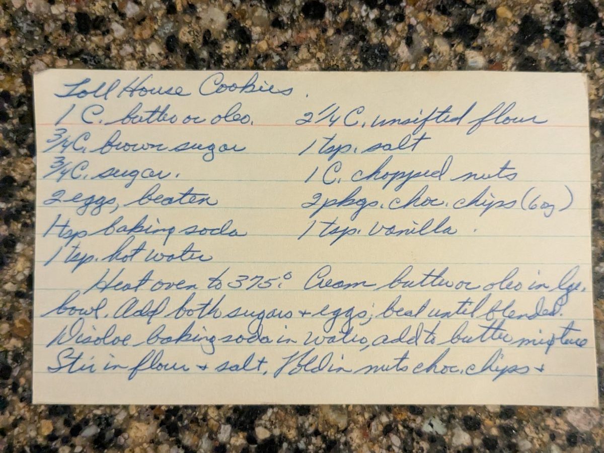 A handwritten index card for Toll House Cookies, in blue cursive on a lined card.